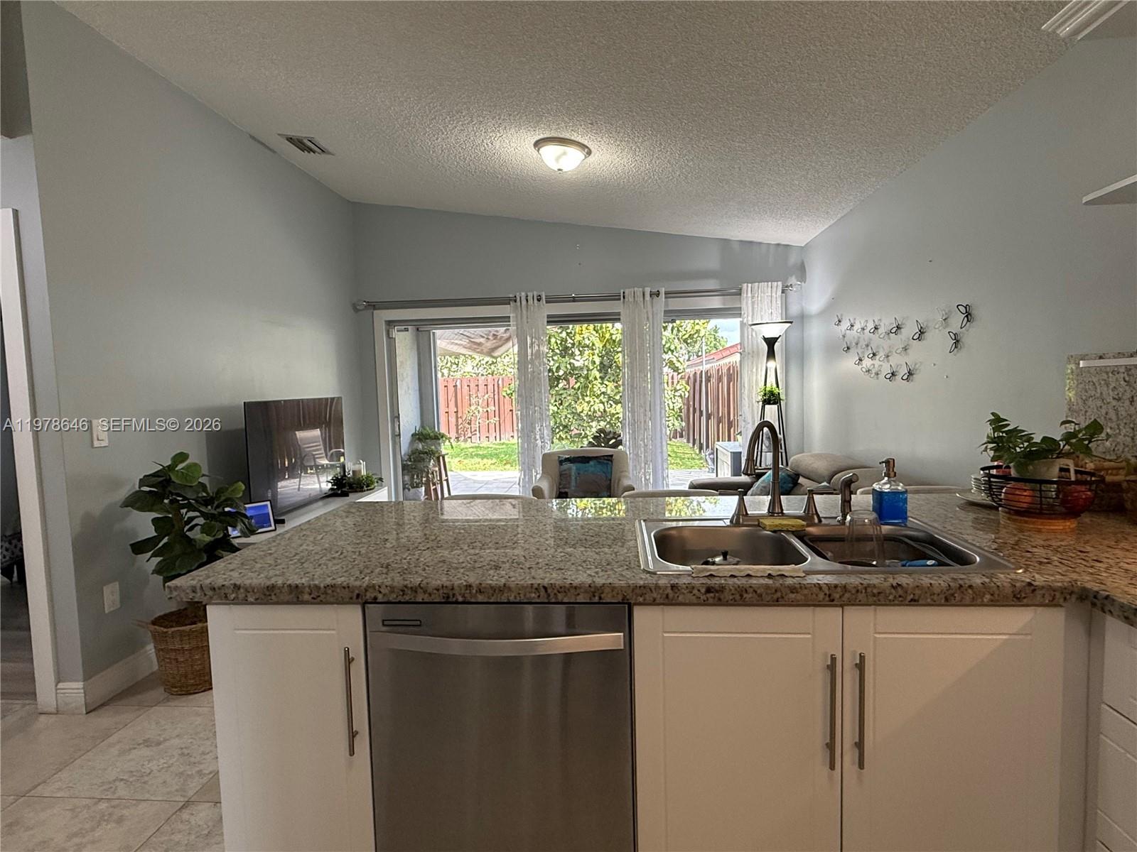 13833 Southwest 157th Street Miami, FL 33177 - Photo 7 of 25 a kitchen with sink and window