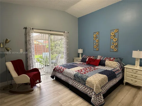 a bedroom with a bed couch and a window