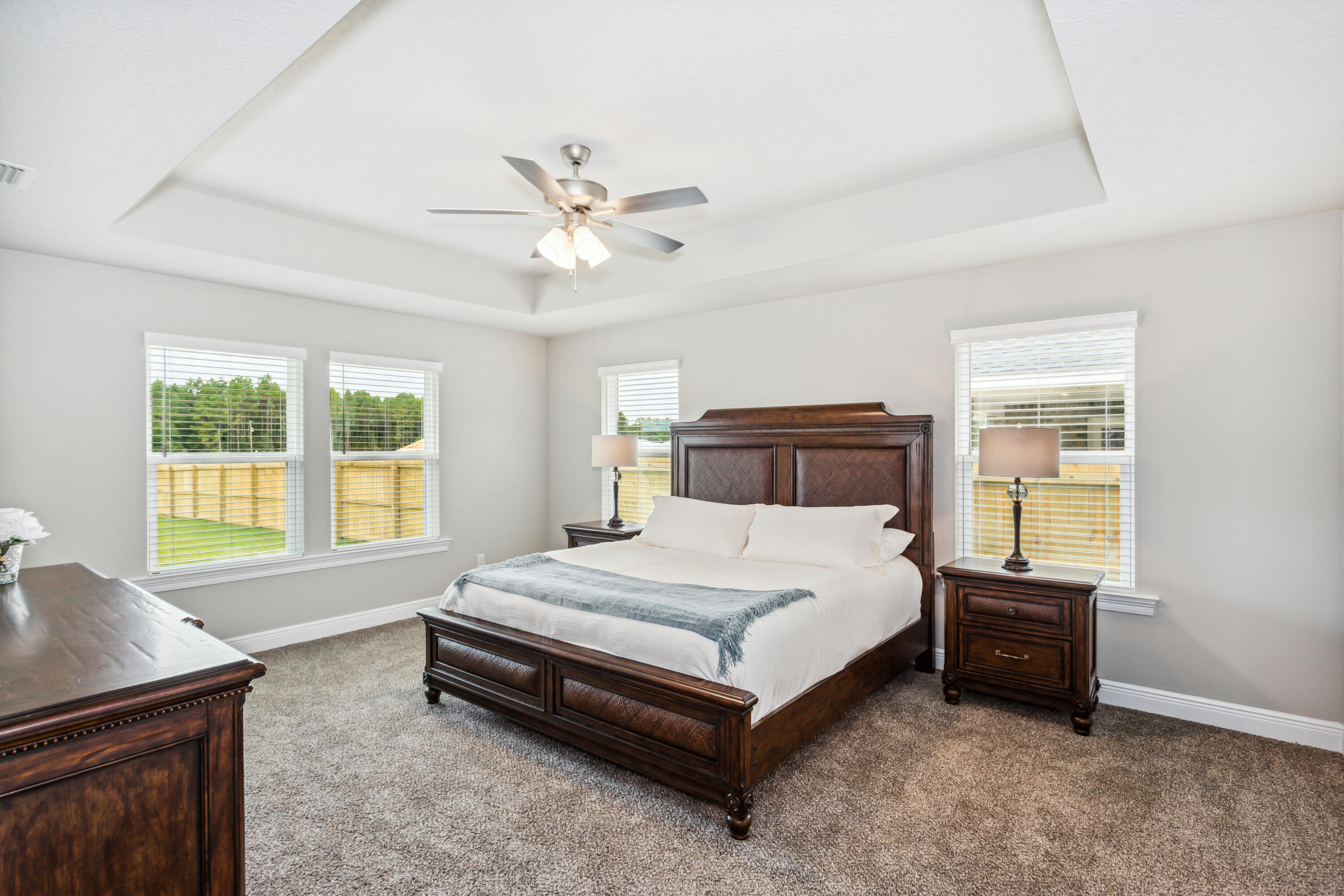 4293 Carl Booker Road Milton, FL 32583 - Photo 24 of 46 a spacious bedroom with a bed a window and a chandelier