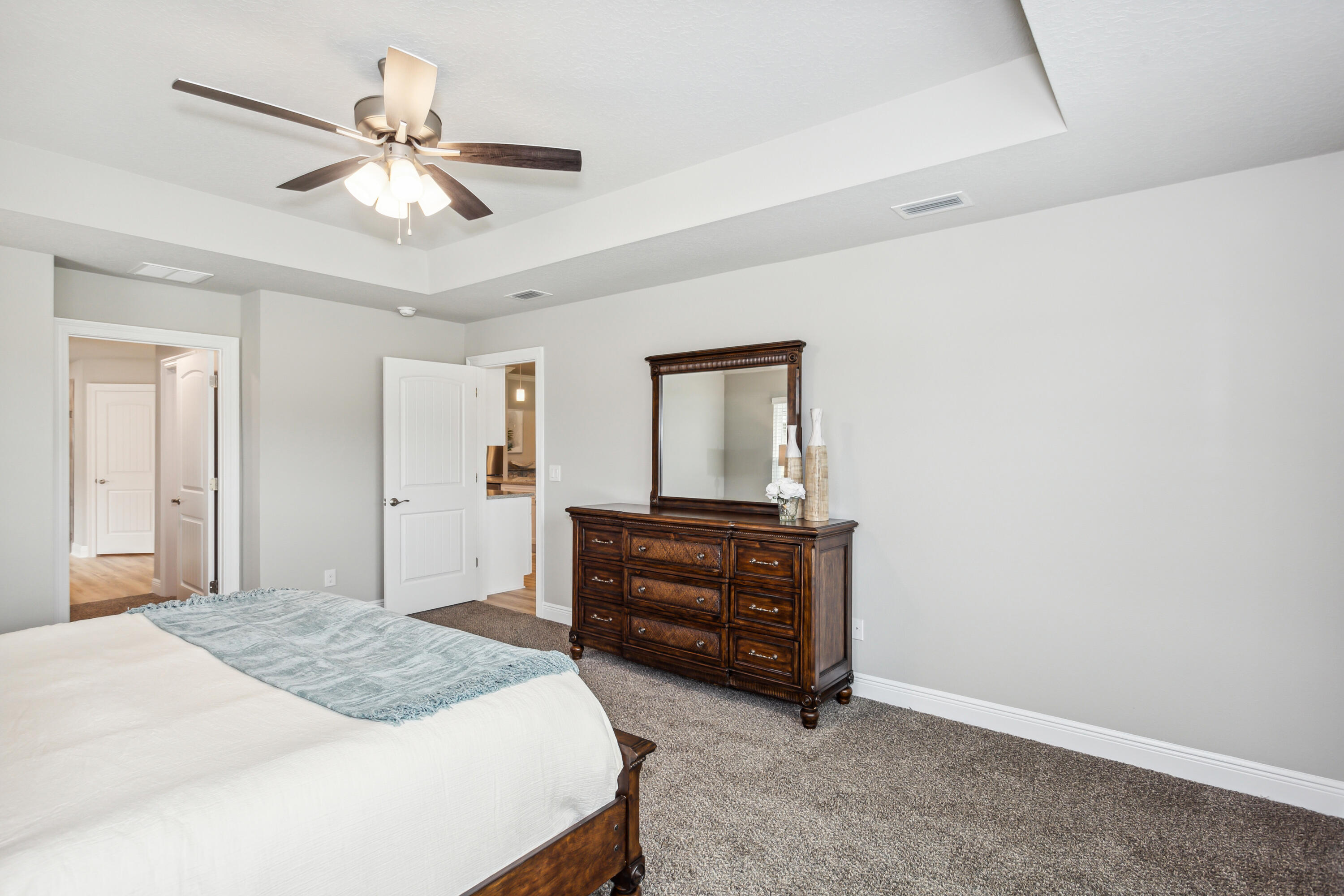 4293 Carl Booker Road Milton, FL 32583 - Photo 26 of 46 a bedroom with a bed and a chandelier