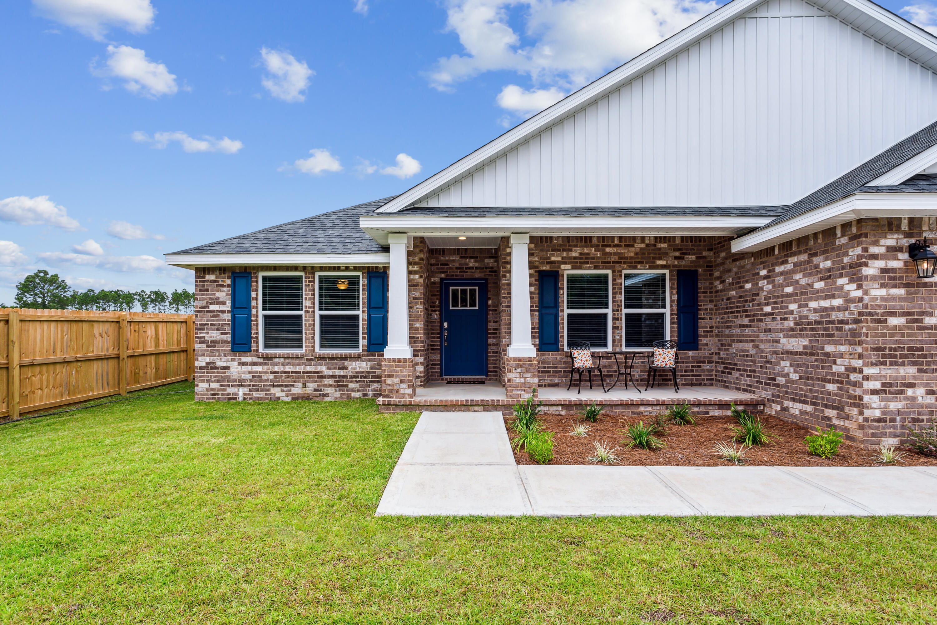 4293 Carl Booker Road Milton, FL 32583 - Photo 3 of 46 a view of a house with a patio and a yard