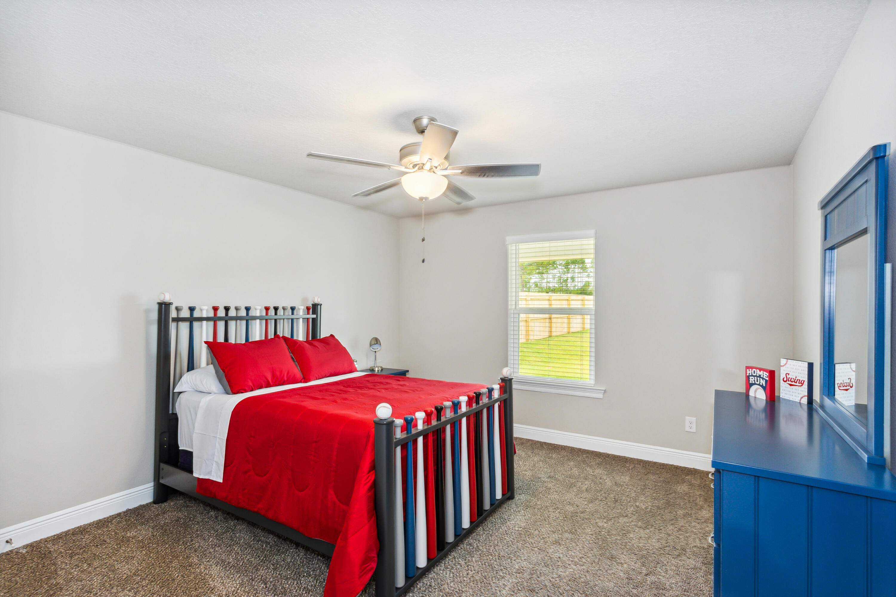 4293 Carl Booker Road Milton, FL 32583 - Photo 35 of 46 a bedroom with a bed and a chandelier
