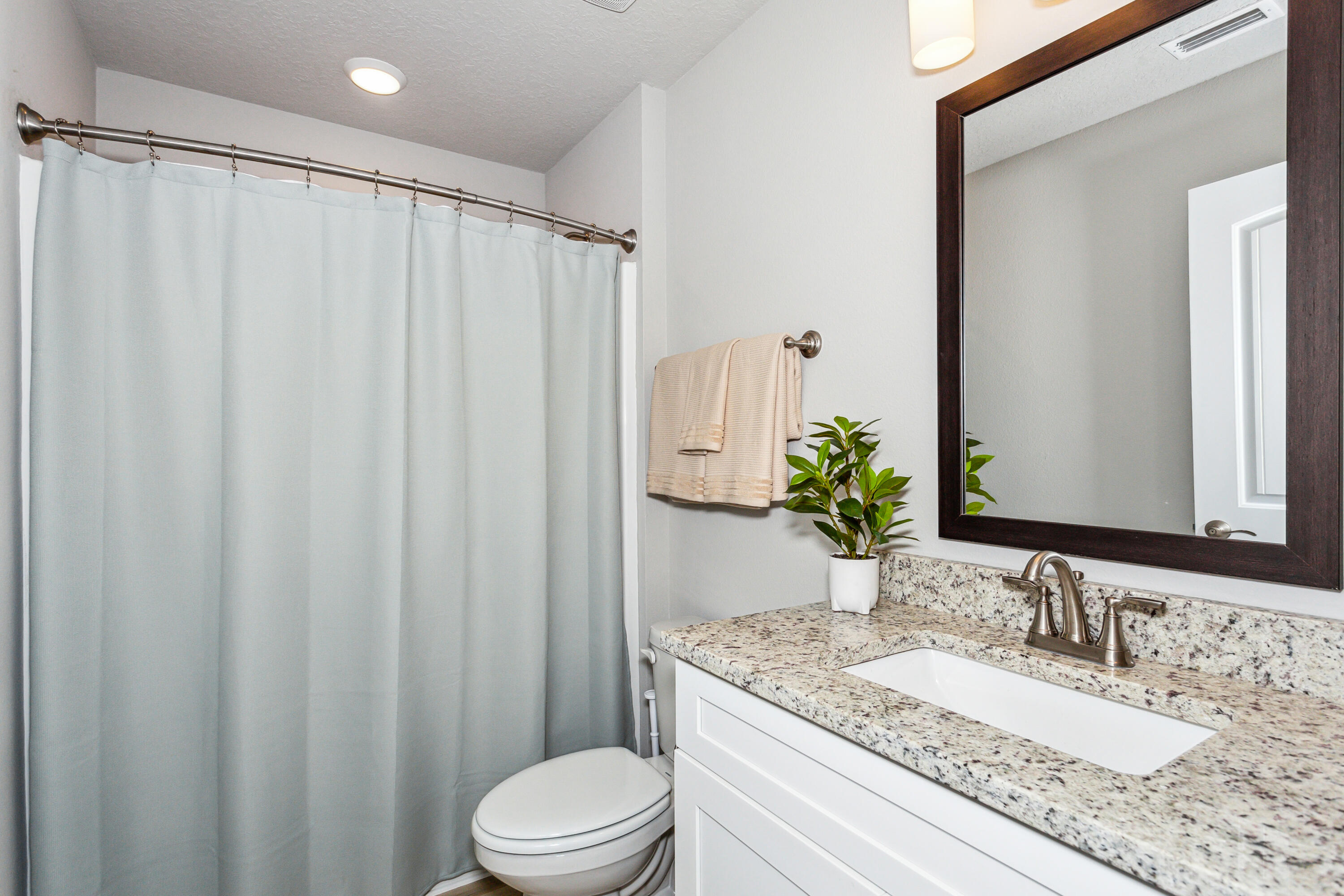 4293 Carl Booker Road Milton, FL 32583 - Photo 37 of 46 a bathroom with a granite countertop sink toilet and shower