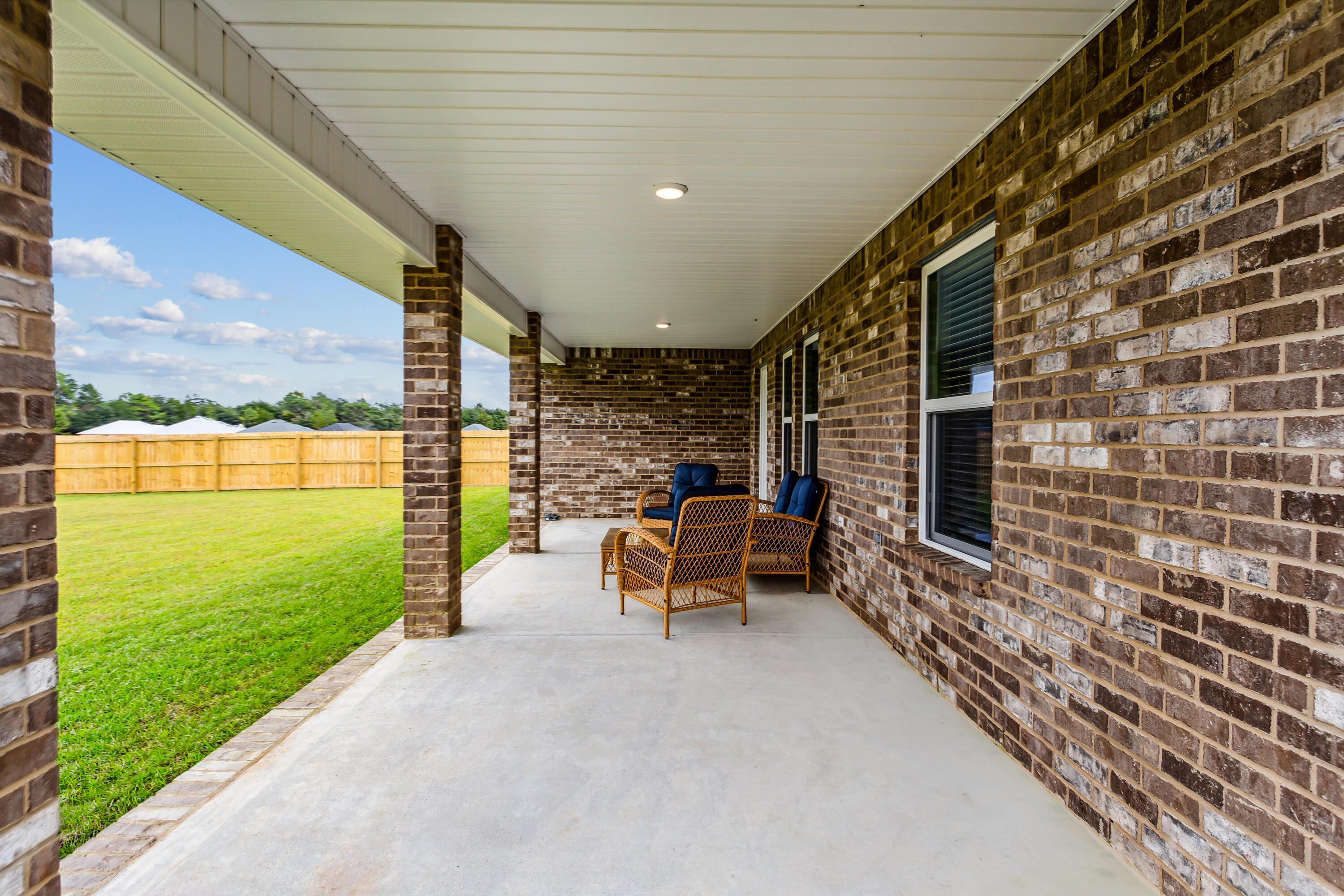 4293 Carl Booker Road Milton, FL 32583 - Photo 41 of 46 a view of a patio with a table and chairs
