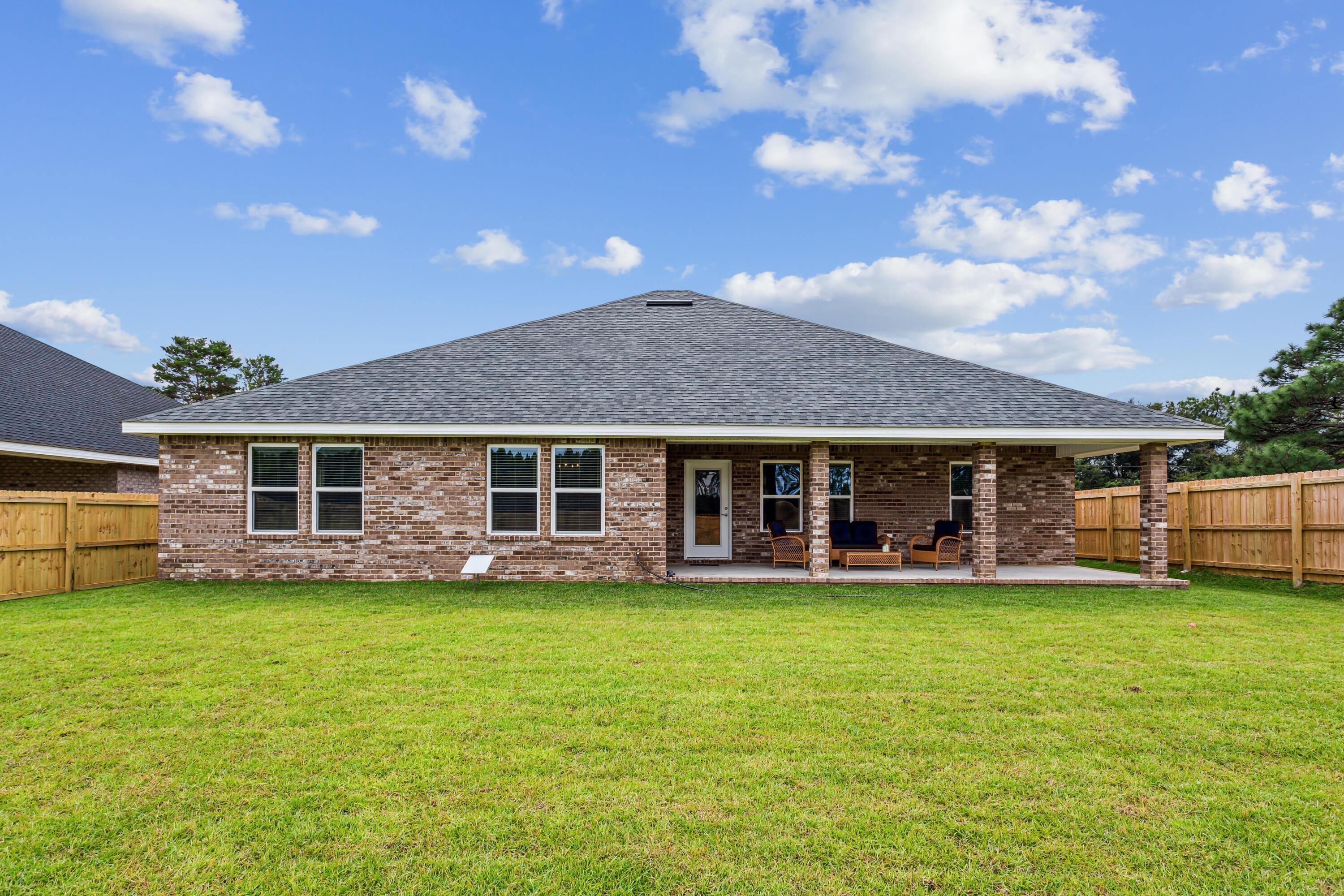 4293 Carl Booker Road Milton, FL 32583 - Photo 44 of 46 a view of a house with a yard and sitting area