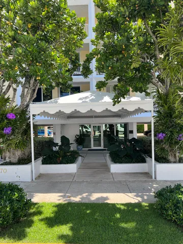 front view of a building with a garden