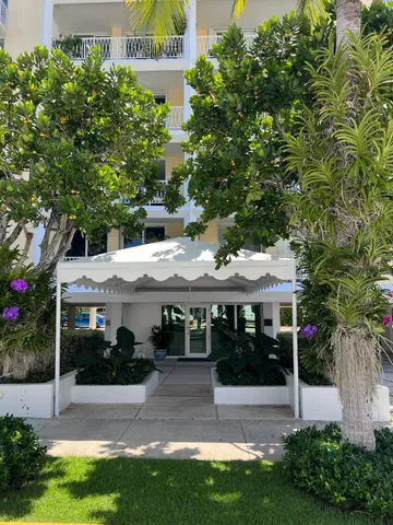 a front view of a house with a tree