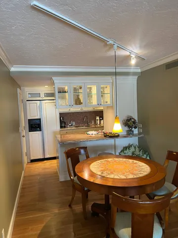 a kitchen with granite countertop white cabinets and stainless steel appliances