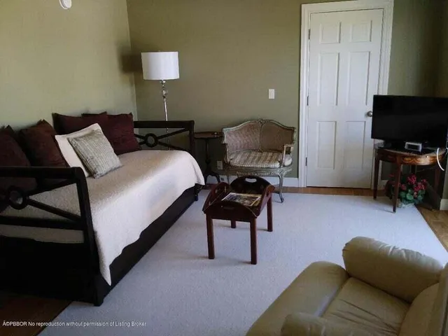 a bathroom with a granite countertop sink a toilet and a mirror