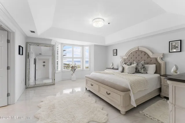 a spacious bathroom with double vanity and a mirror