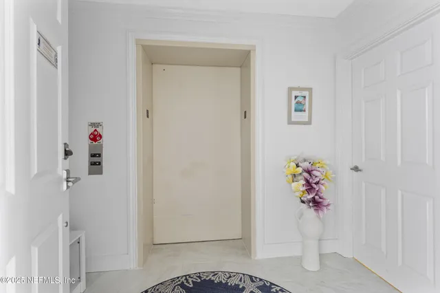 a view of a hallway with wooden floor and entryway