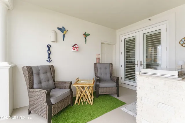 a balcony with furniture and a potted plant