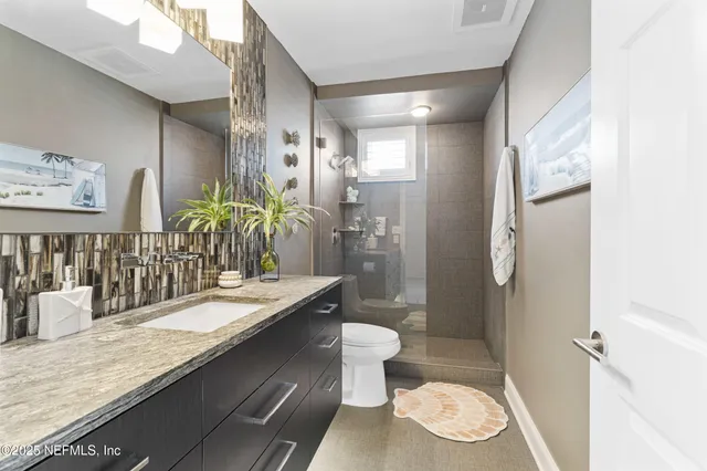 a bathroom with a sink toilet and shower