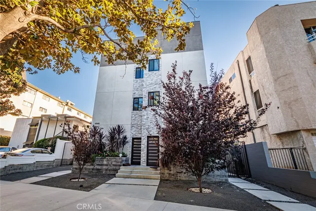 front view of a house with a tree