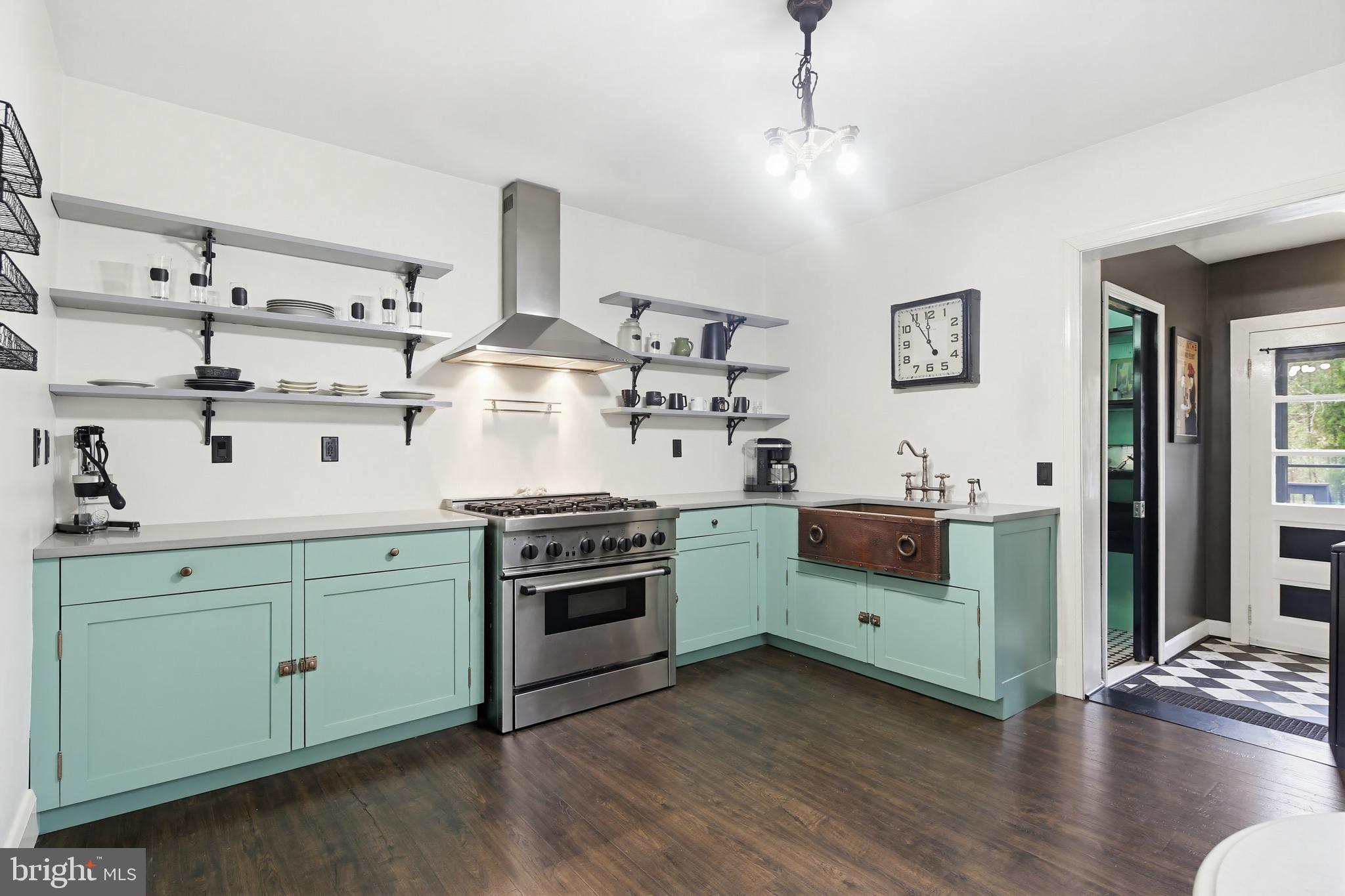 8556 Frederick Road Ellicott City, MD 21043 - Photo 13 of 38 a kitchen with stainless steel appliances a stove and white cabinets