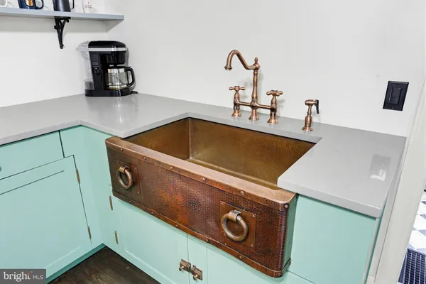 a kitchen with stainless steel appliances a stove and white cabinets