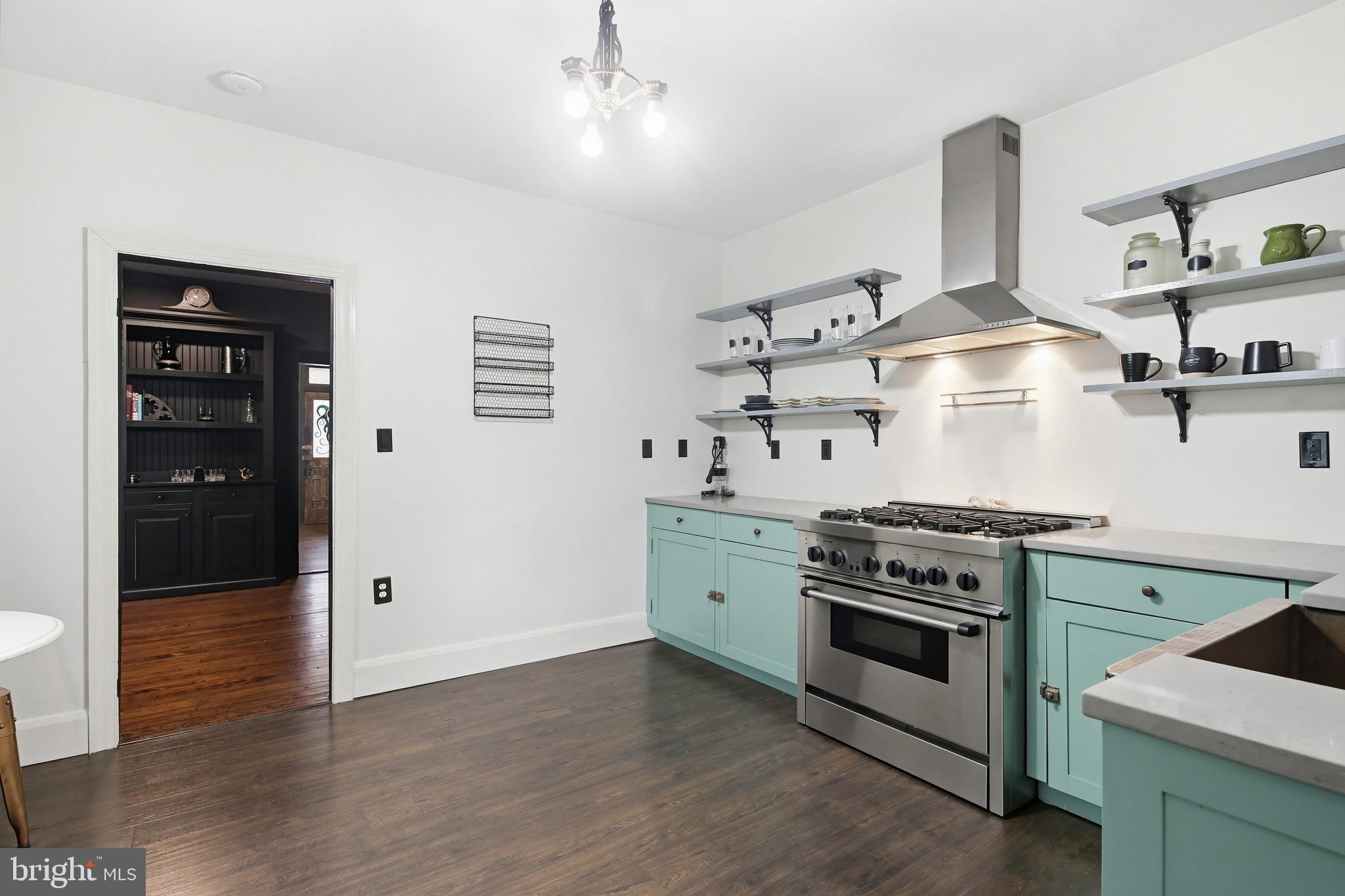 8556 Frederick Road Ellicott City, MD 21043 - Photo 16 of 38 a kitchen with stainless steel appliances a stove and white cabinets