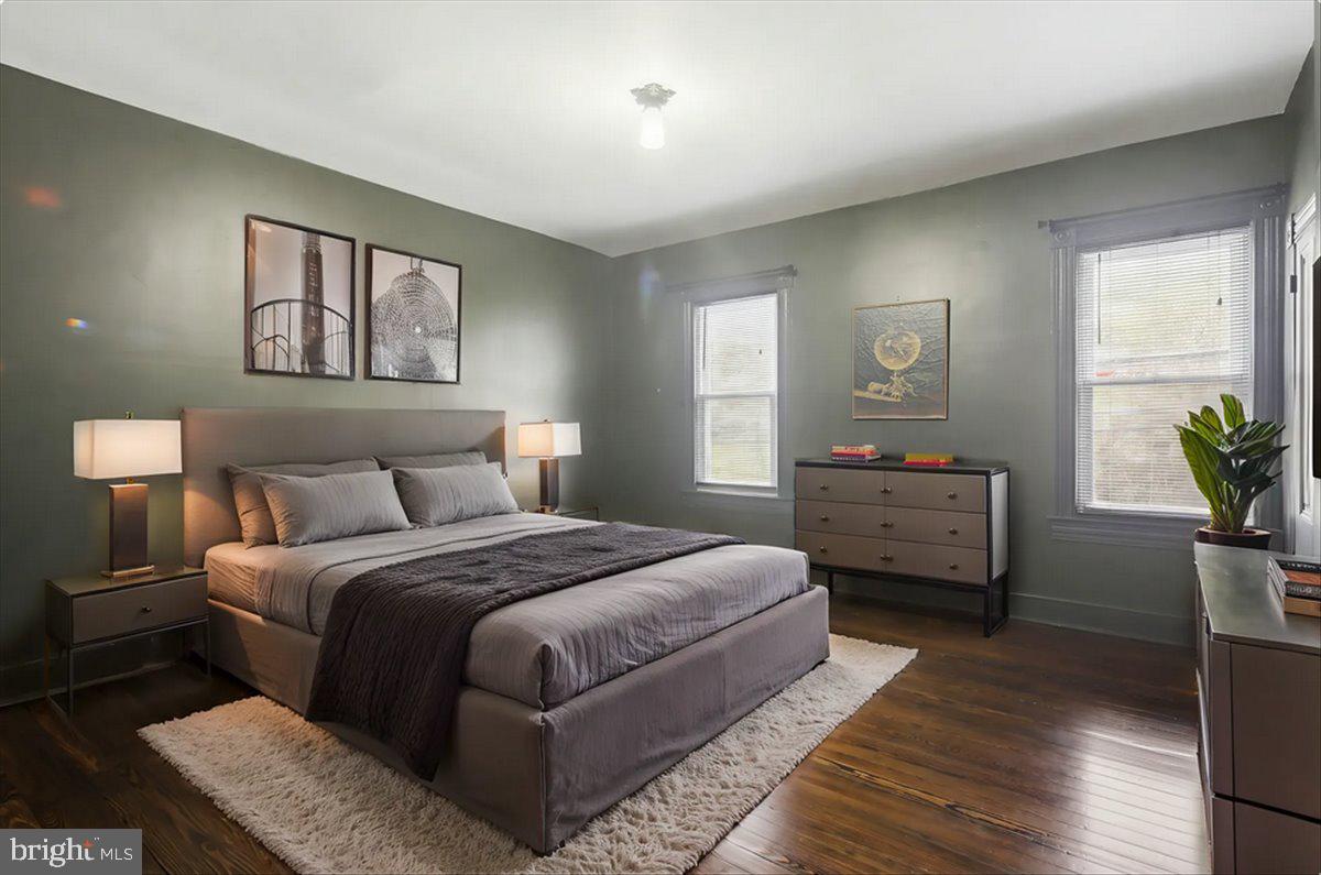 8556 Frederick Road Ellicott City, MD 21043 - Photo 17 of 38 a bedroom with a bed and a potted plant