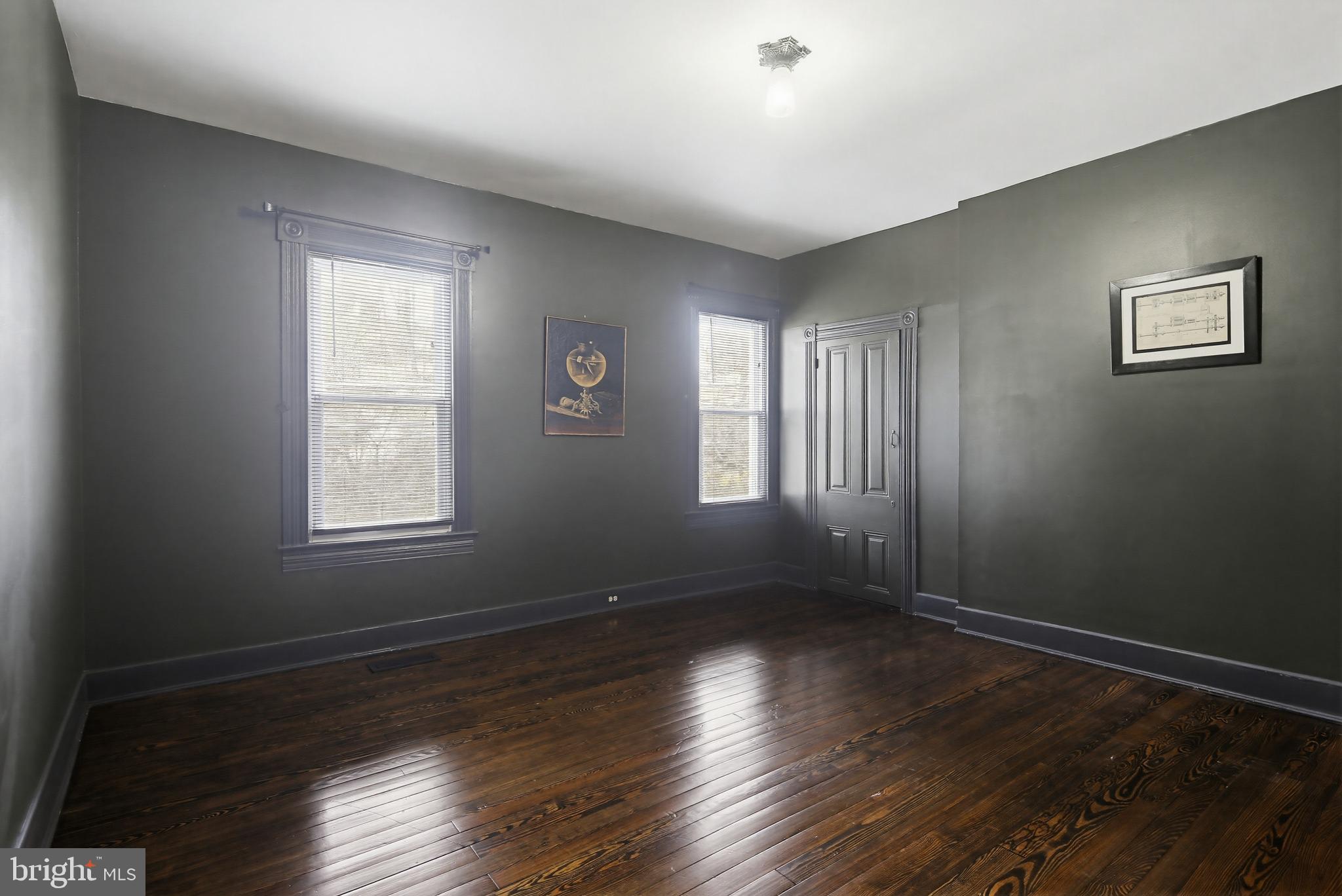 8556 Frederick Road Ellicott City, MD 21043 - Photo 20 of 38 a view of an empty room with wooden floor and a window