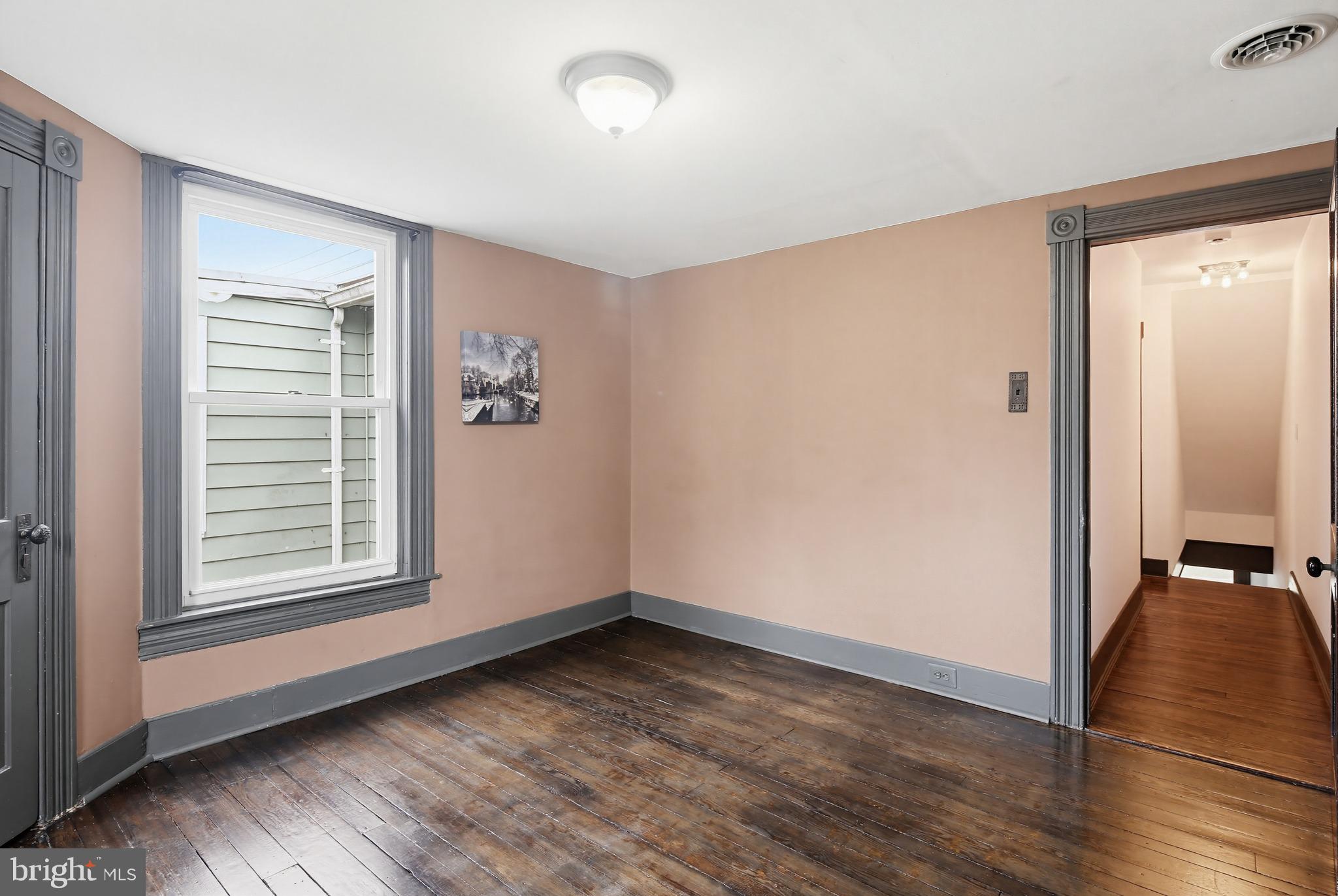 8556 Frederick Road Ellicott City, MD 21043 - Photo 23 of 38 an empty room with wooden floor and windows