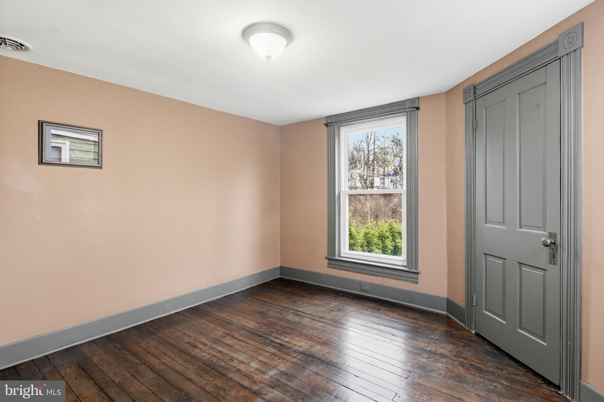 8556 Frederick Road Ellicott City, MD 21043 - Photo 24 of 38 an empty room with wooden floor and windows
