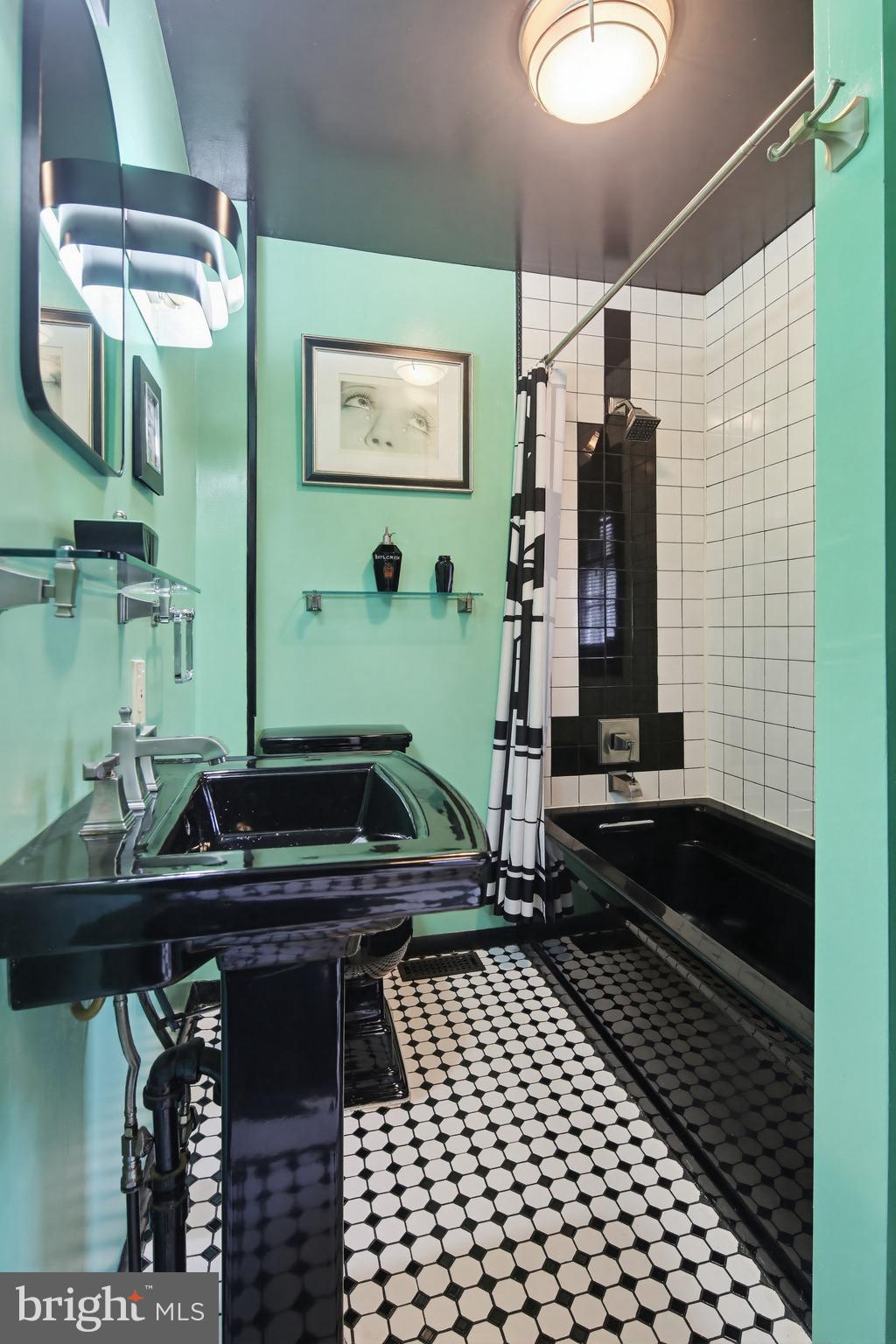 8556 Frederick Road Ellicott City, MD 21043 - Photo 28 of 38 a bathroom with a sink and a mirror