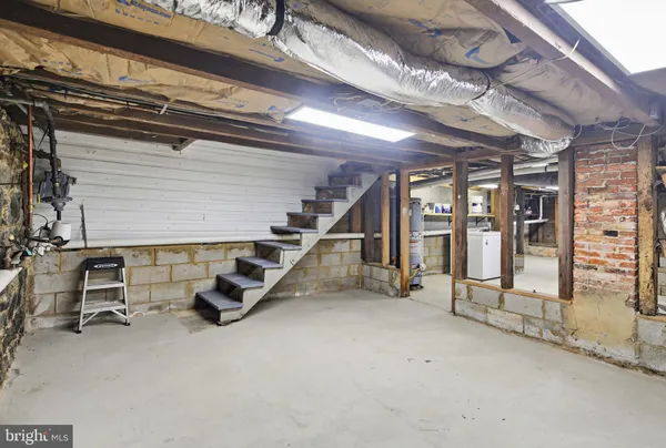 a view of a house with a deck and furniture