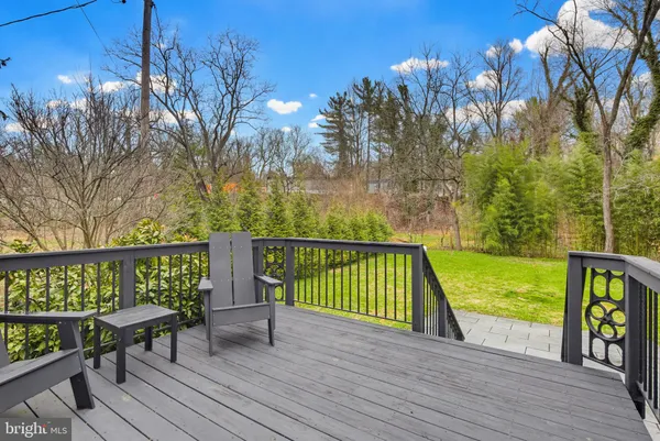 a view of a patio with table and chairs with wooden floor and fence