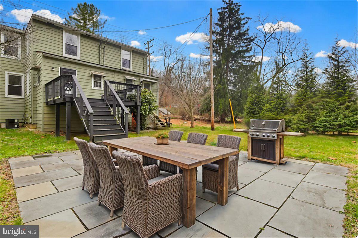8556 Frederick Road Ellicott City, MD 21043 - Photo 33 of 38 a view of a patio with table and chairs with wooden floor and fence