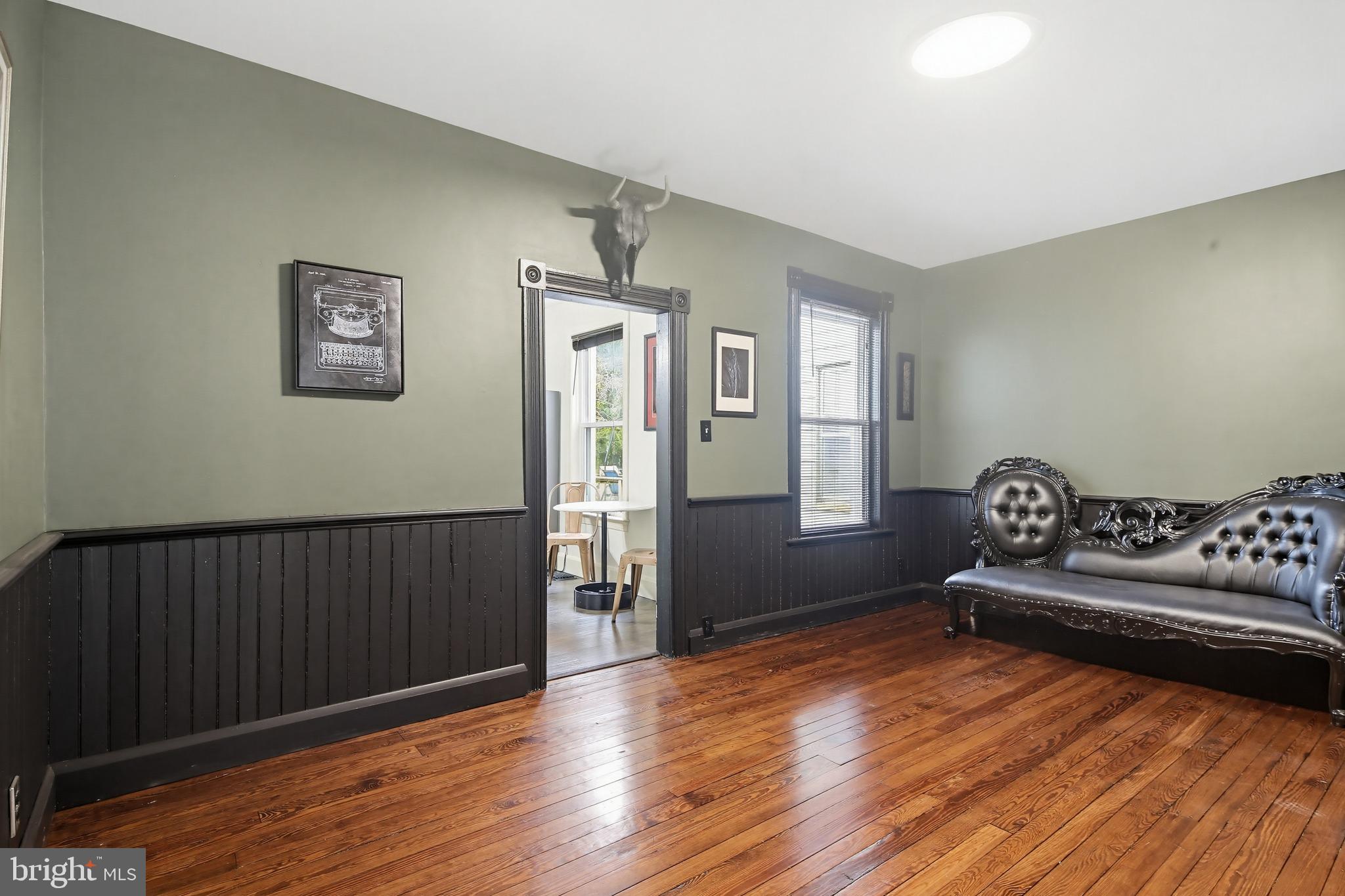 8556 Frederick Road Ellicott City, MD 21043 - Photo 8 of 38 a living room with furniture and a wooden floor