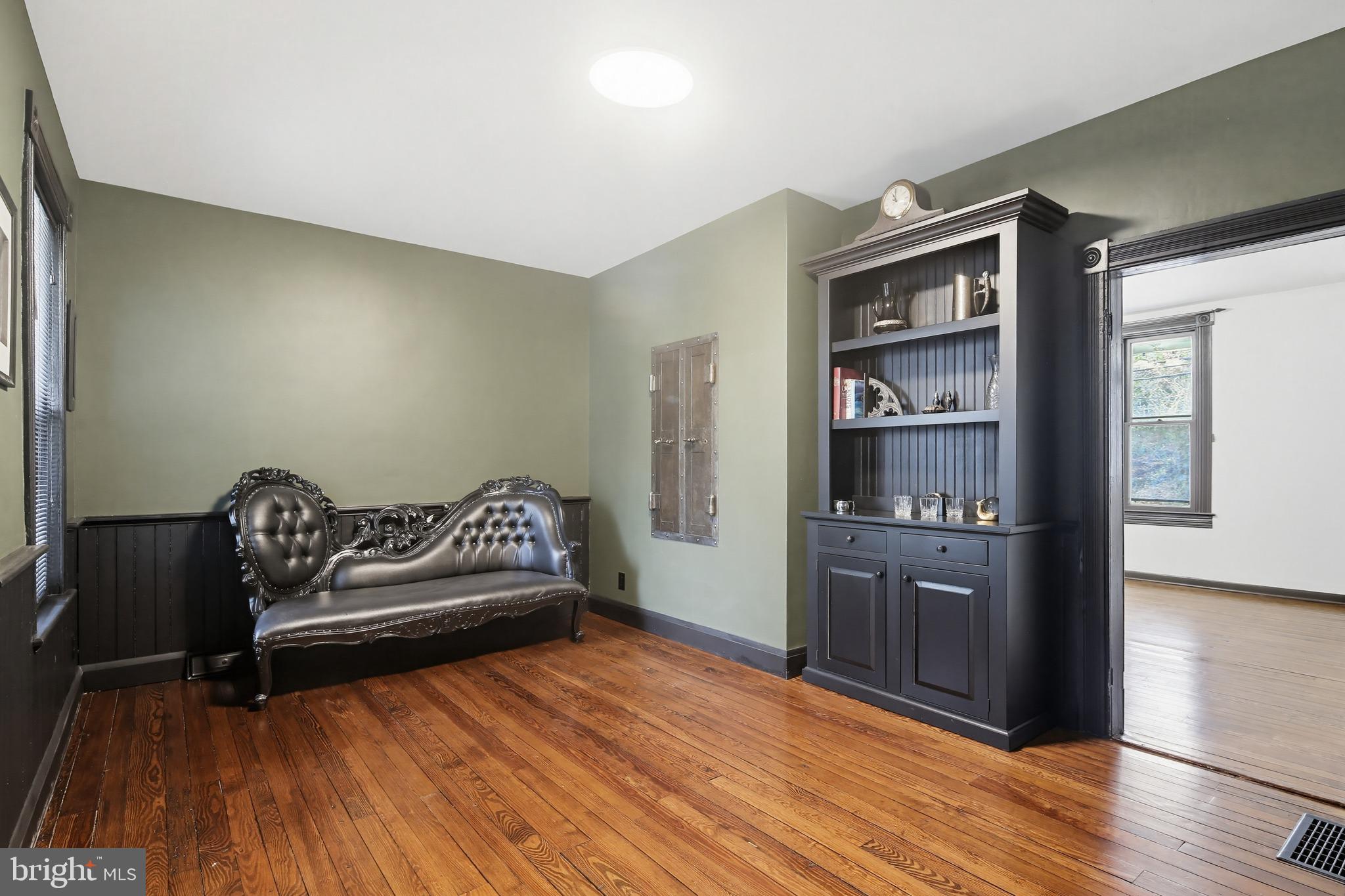 8556 Frederick Road Ellicott City, MD 21043 - Photo 9 of 38 a bedroom with a bed and wooden floor