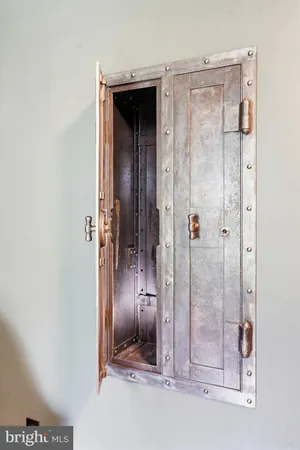 a view of an empty room with closet and a window
