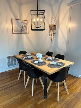 a view of a dining room with furniture and wooden floor