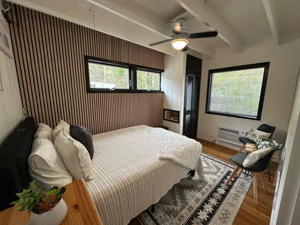 a bedroom with a bed and a flat screen tv