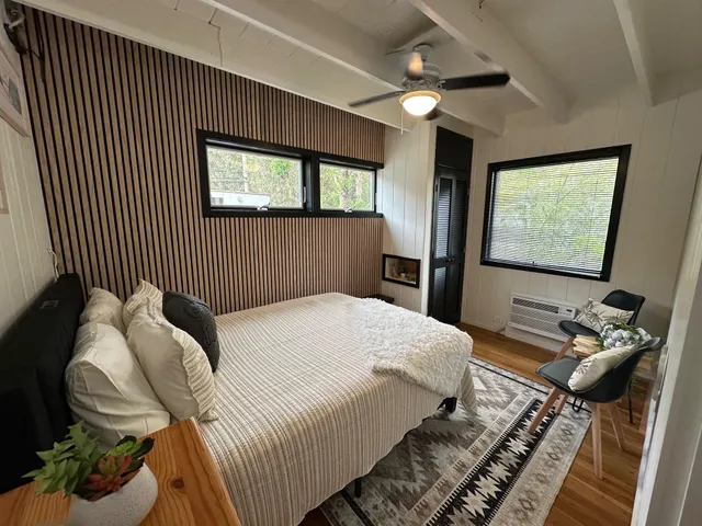 a bedroom with a bed and a flat screen tv