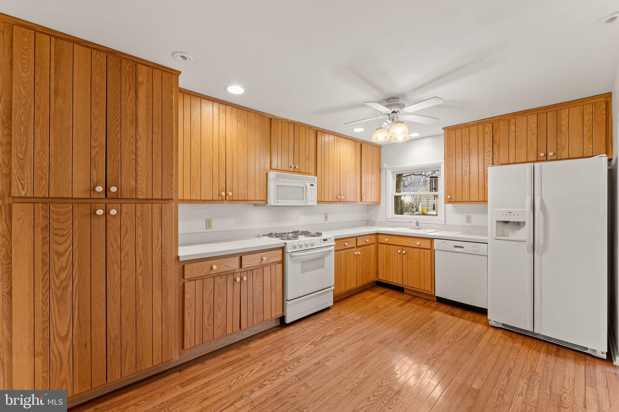 1022 Crozer Lane Springfield, PA 19064 - Photo 11 of 42 a kitchen with a white cabinets and wooden floor