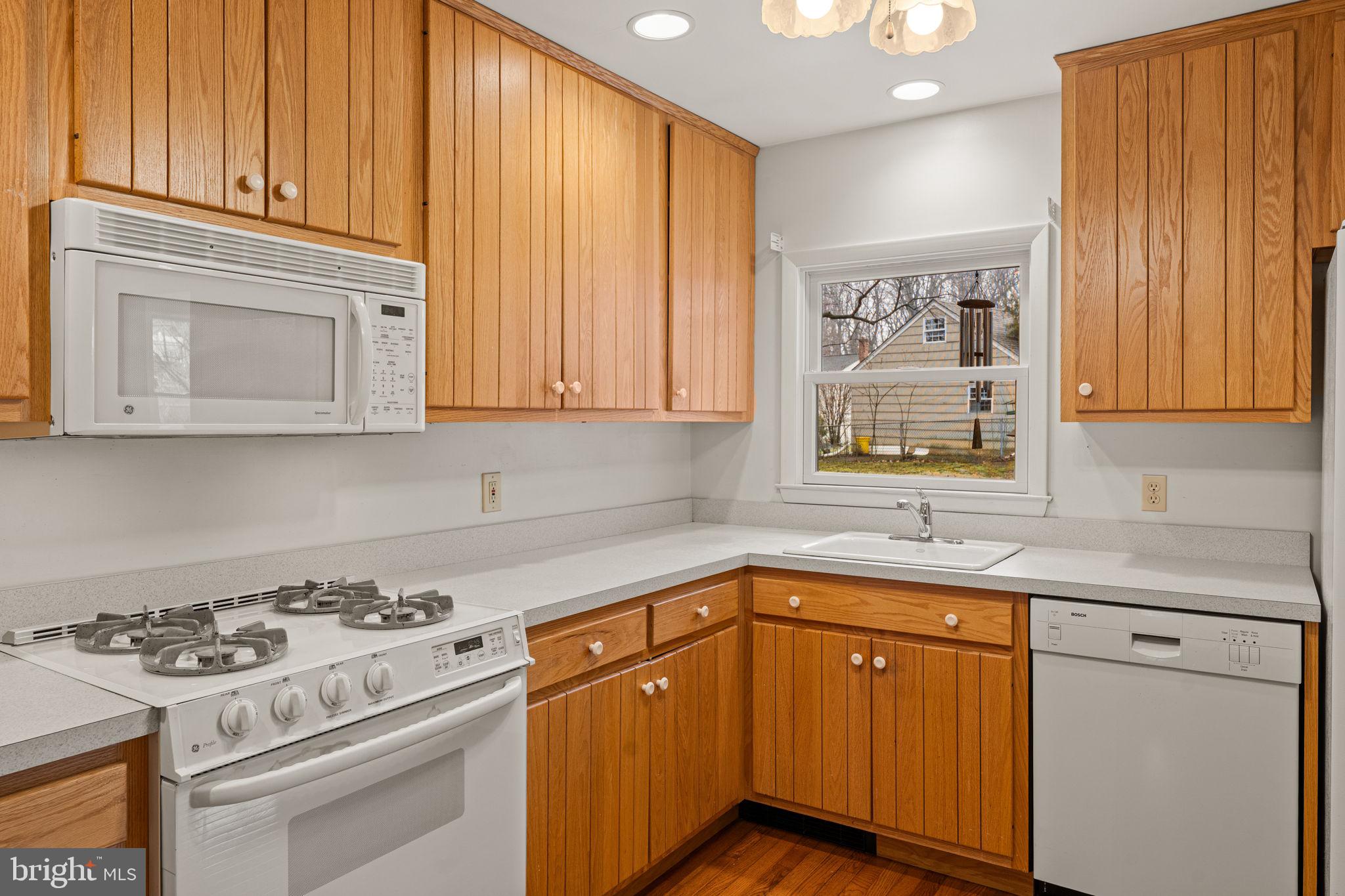 1022 Crozer Lane Springfield, PA 19064 - Photo 12 of 42 a kitchen with stainless steel appliances granite countertop a sink stove and cabinets