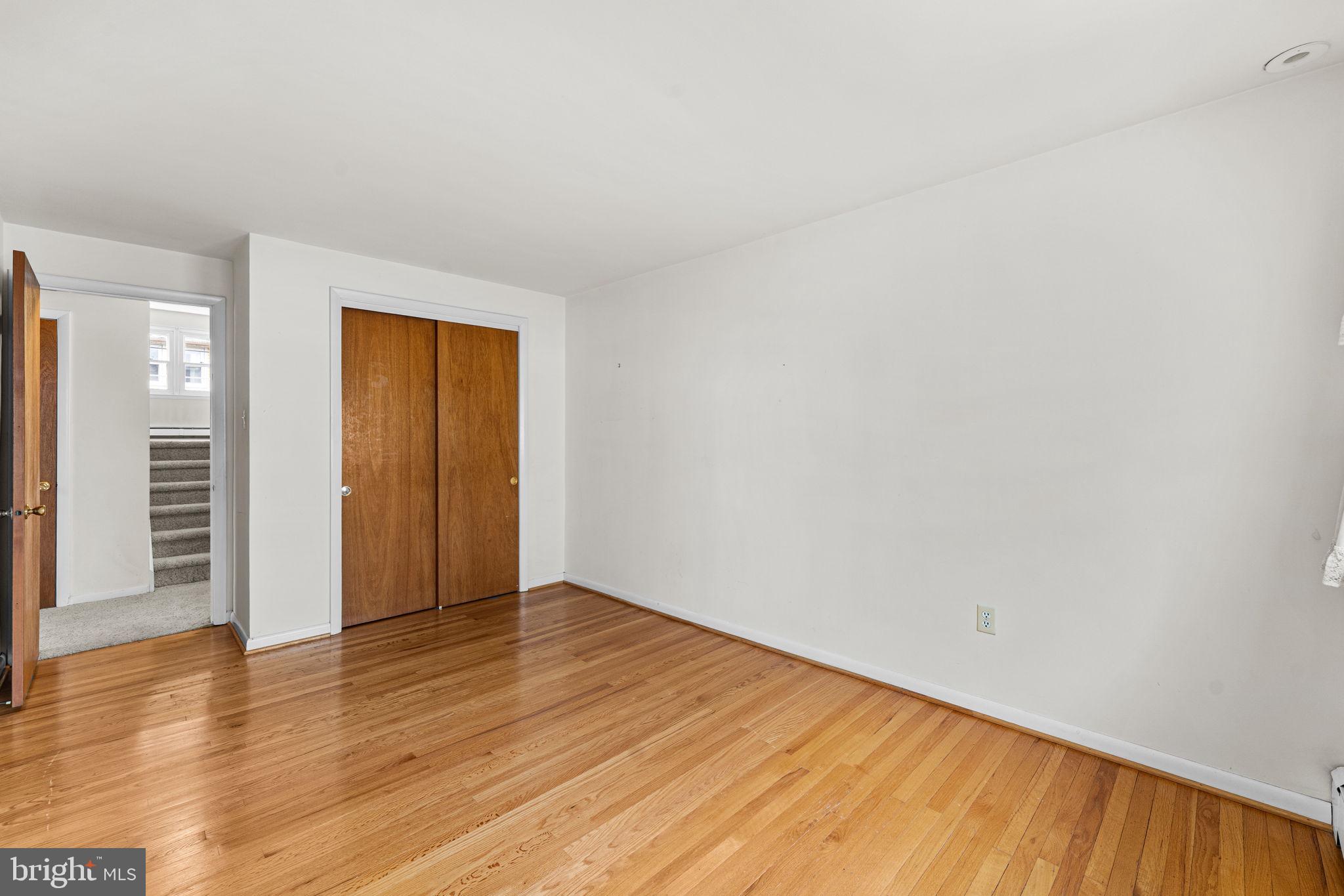 1022 Crozer Lane Springfield, PA 19064 - Photo 18 of 42 a view of an empty room with wooden floor and closet
