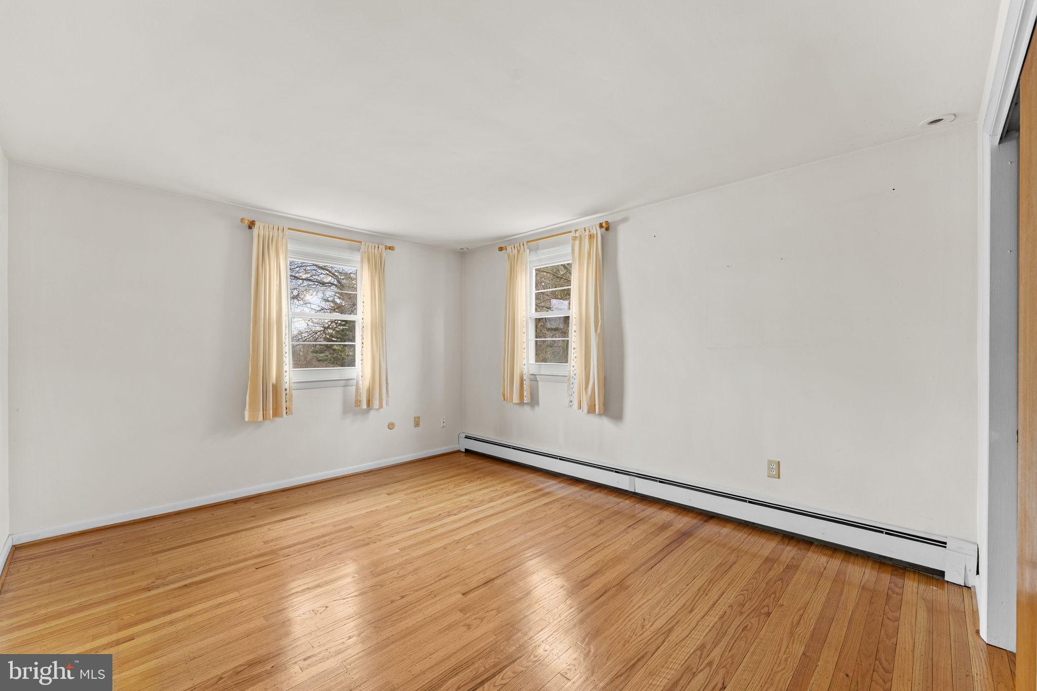 1022 Crozer Lane Springfield, PA 19064 - Photo 20 of 42 an empty room with wooden floor and windows