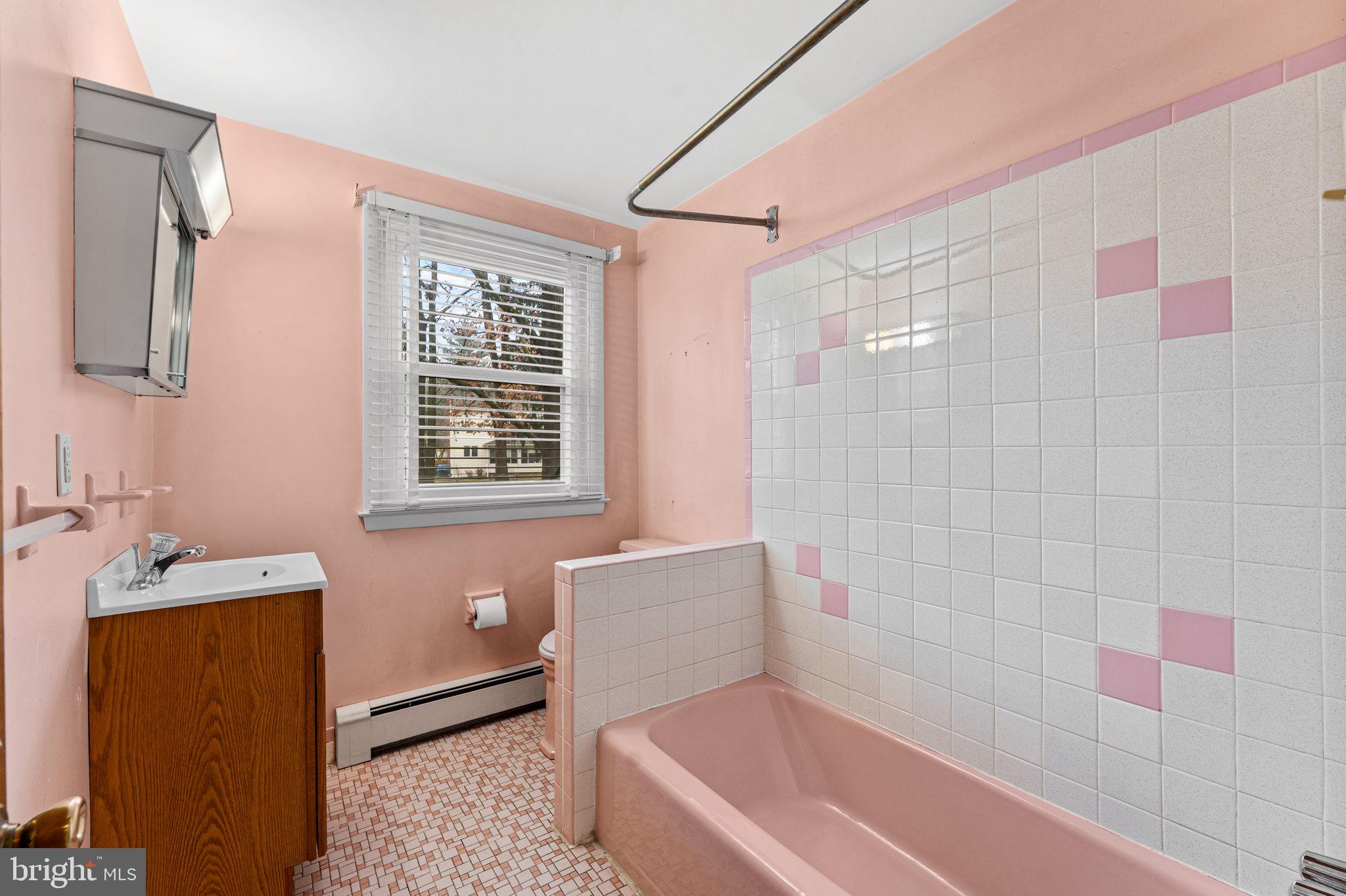 1022 Crozer Lane Springfield, PA 19064 - Photo 22 of 42 a bathroom with a bathtub a sink a window and a shower