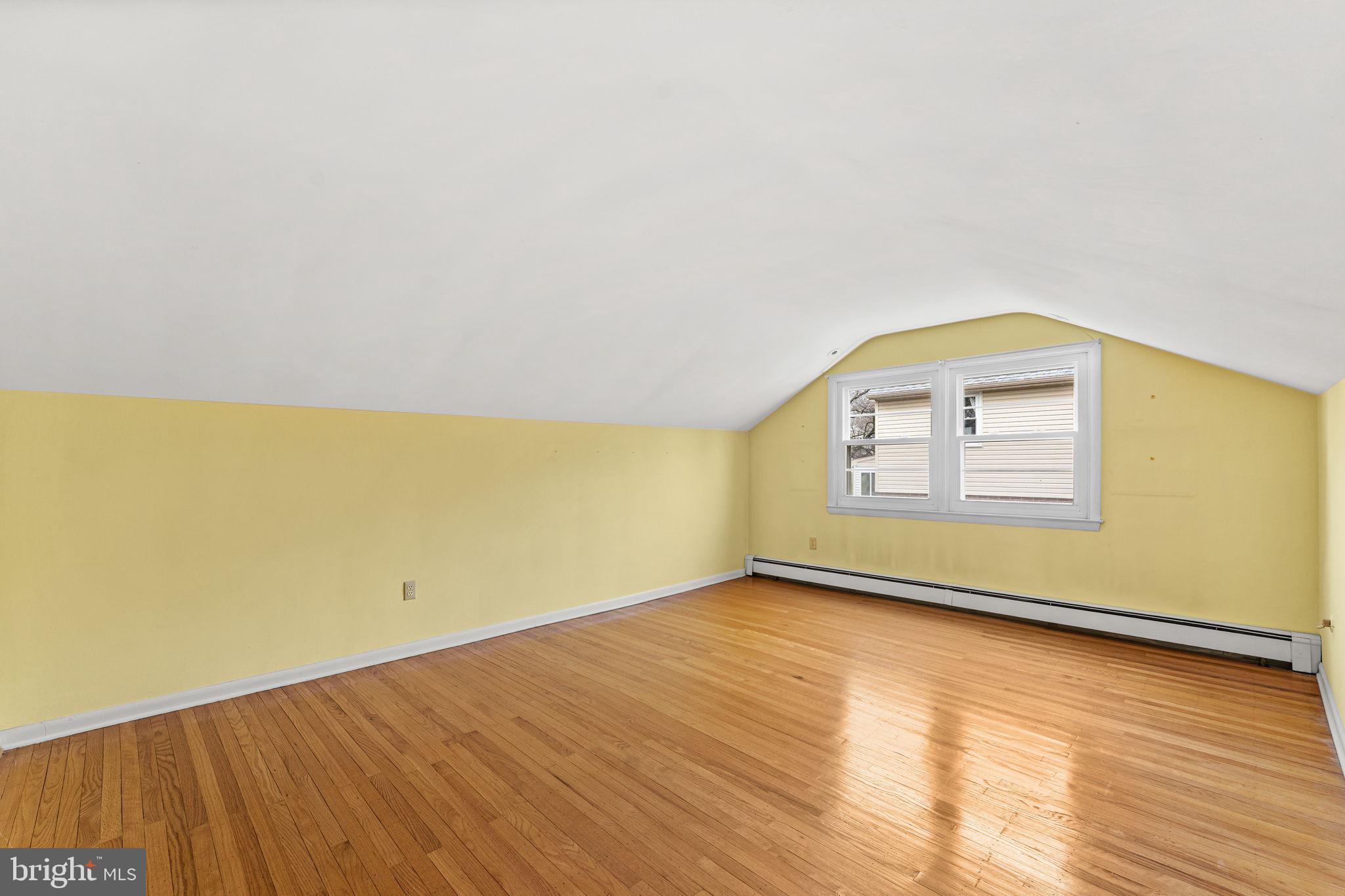 1022 Crozer Lane Springfield, PA 19064 - Photo 24 of 42 a view of an empty room with wooden floor and a window