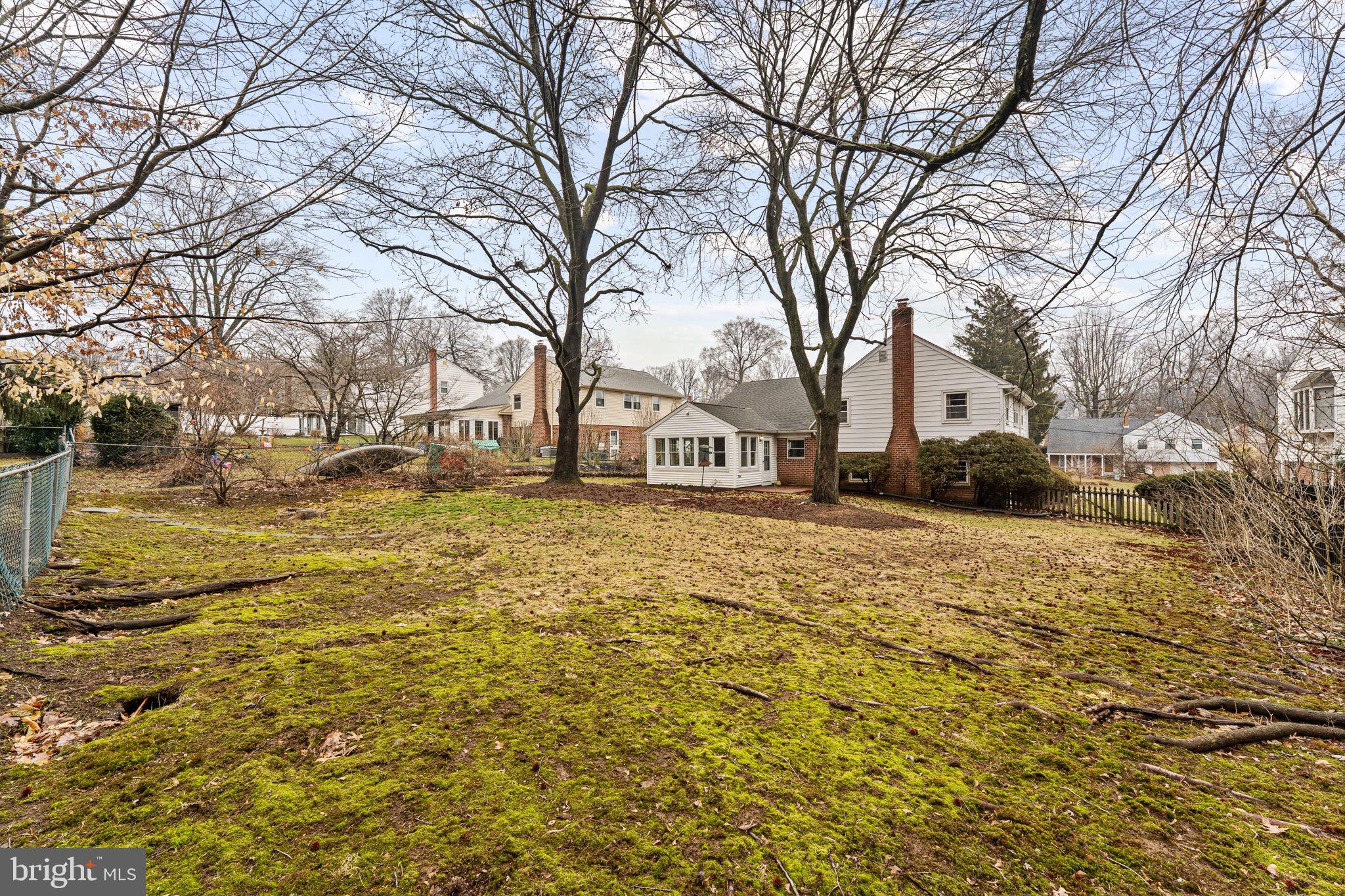 1022 Crozer Lane Springfield, PA 19064 - Photo 33 of 42 a front view of a house with a yard covered with snow and trees