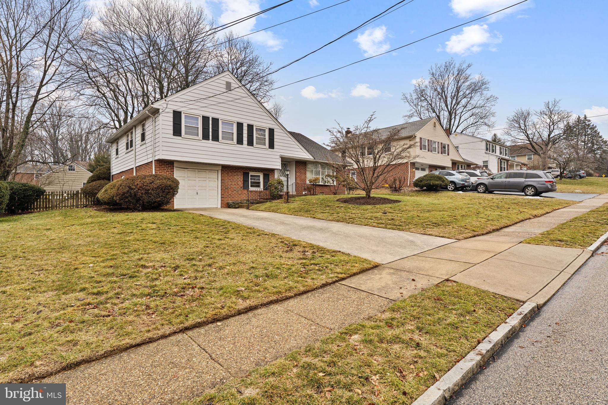 1022 Crozer Lane Springfield, PA 19064 - Photo 37 of 42 a view of a white house with a yard