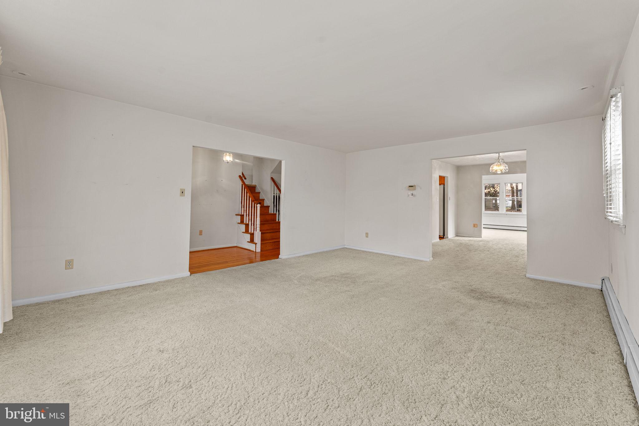 1022 Crozer Lane Springfield, PA 19064 - Photo 6 of 42 a view of an empty room with wooden floor and windows