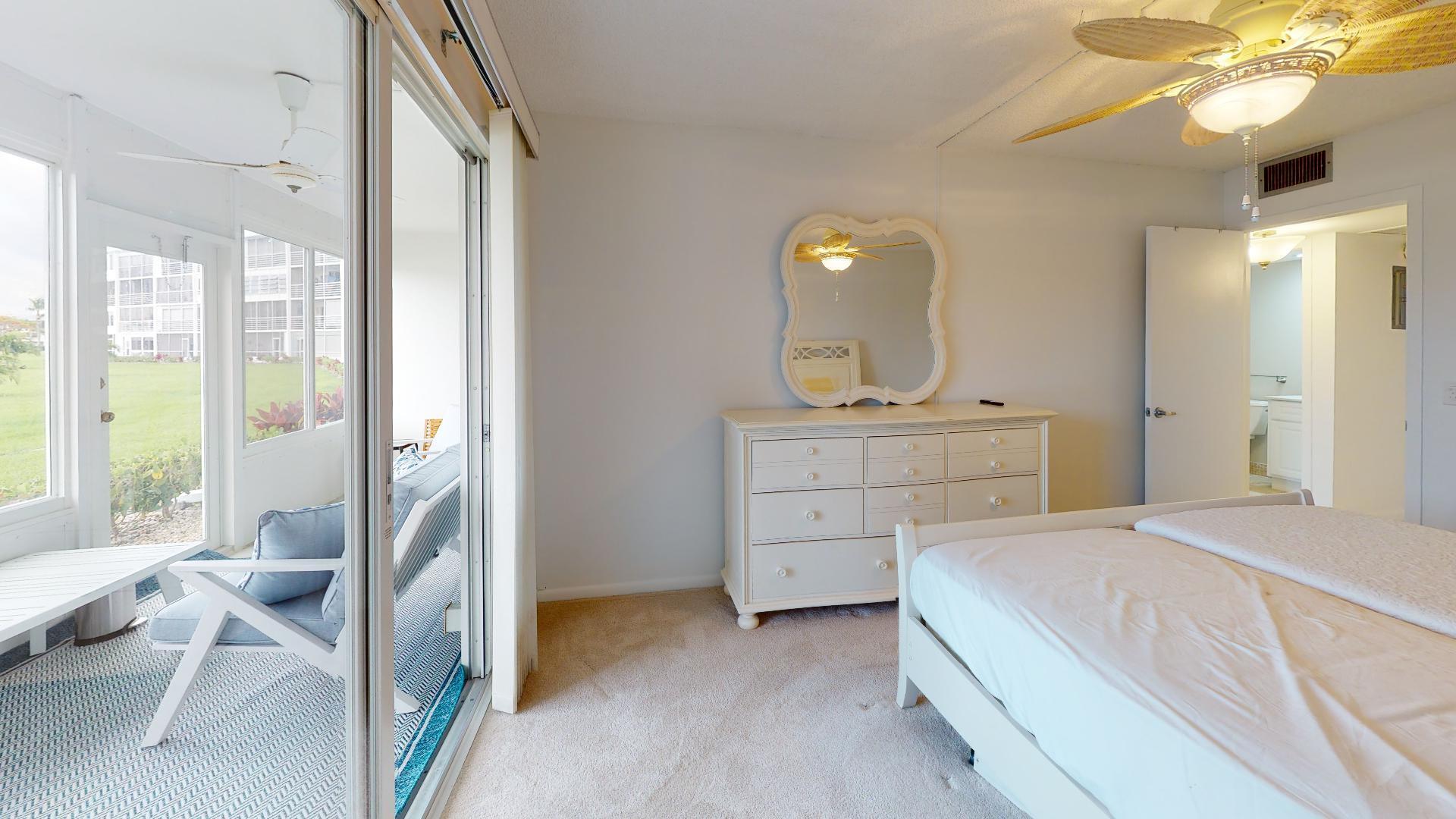 1014 Exeter Boca Raton, FL 33434 - Photo 16 of 31 a bedroom with a bed and a chandelier