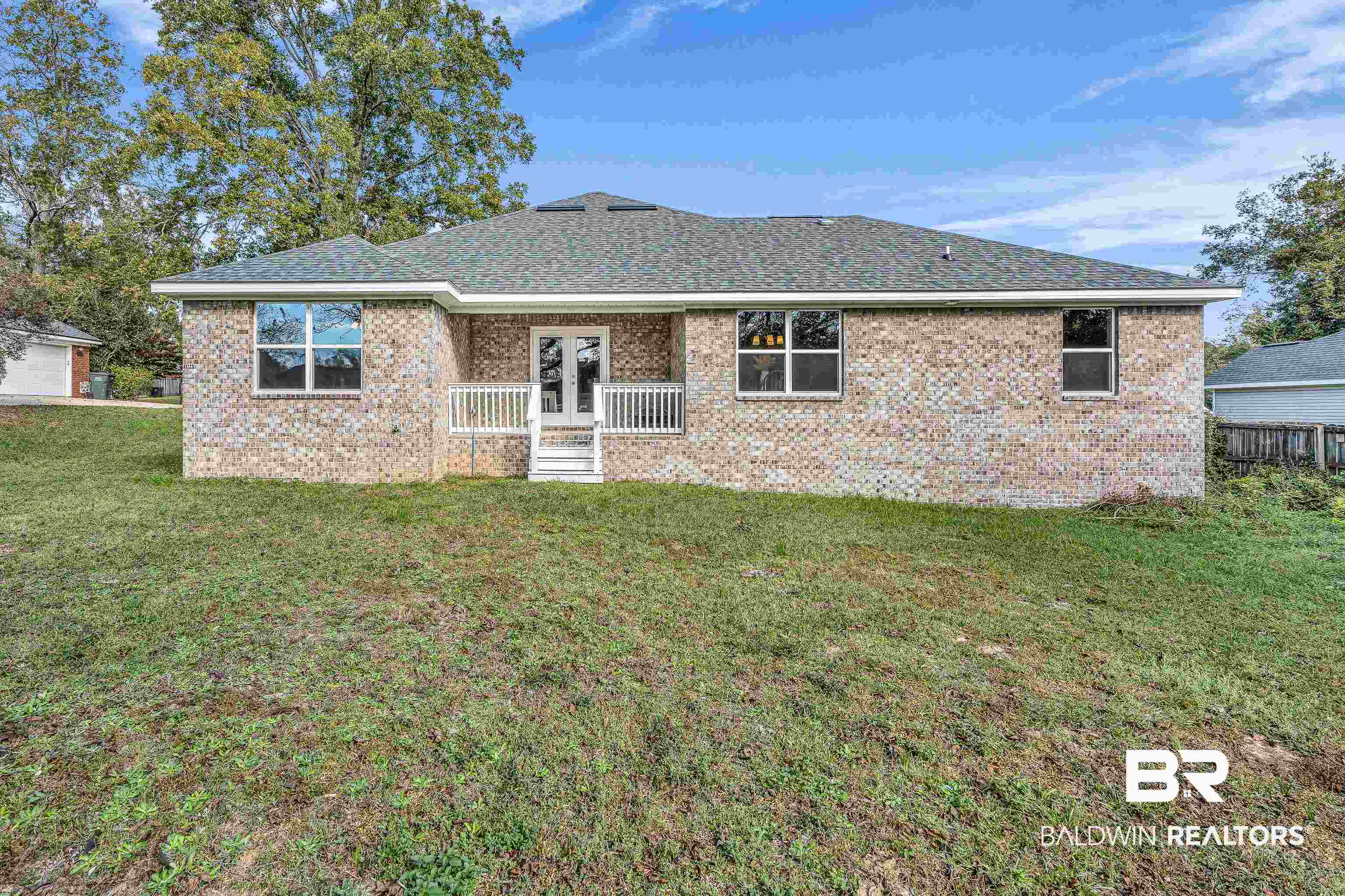 9206 Greenleaf Drive Daphne, AL 36527 - Photo 30 of 32 Back of property with a yard, brick siding, french doors, and a shingled roof