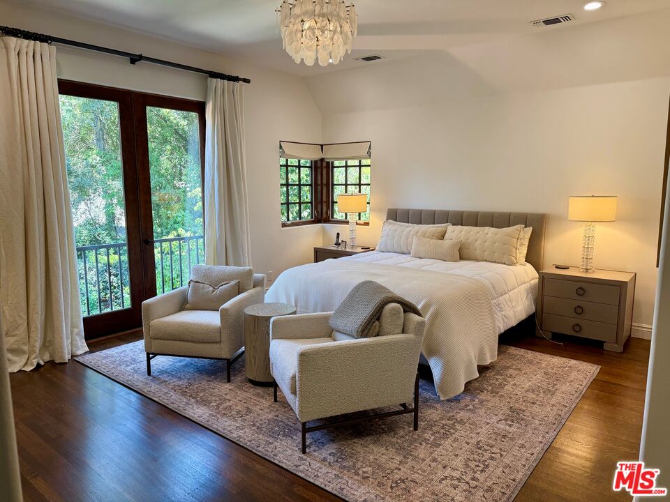 530 Hawthorn Road Sacramento, CA 95864 - Photo 13 of 23 a bedroom with a bed couches and a large window with wooden floor