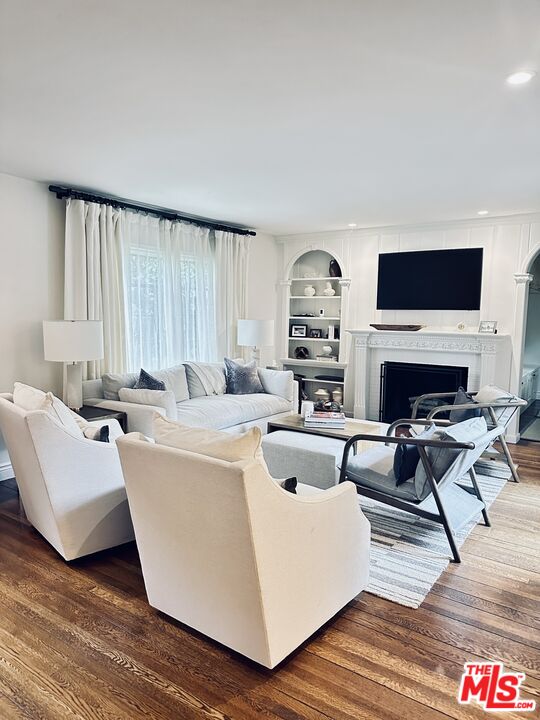 530 Hawthorn Road Sacramento, CA 95864 - Photo 3 of 23 a living room with furniture a flat screen tv and a fireplace