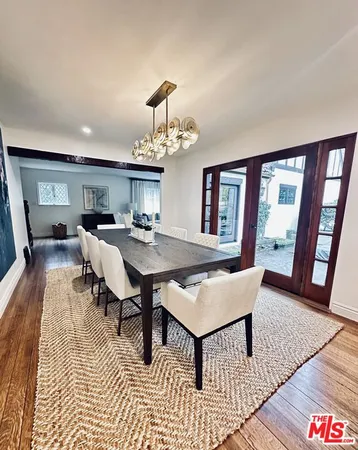 a living room with furniture a rug and a chandelier