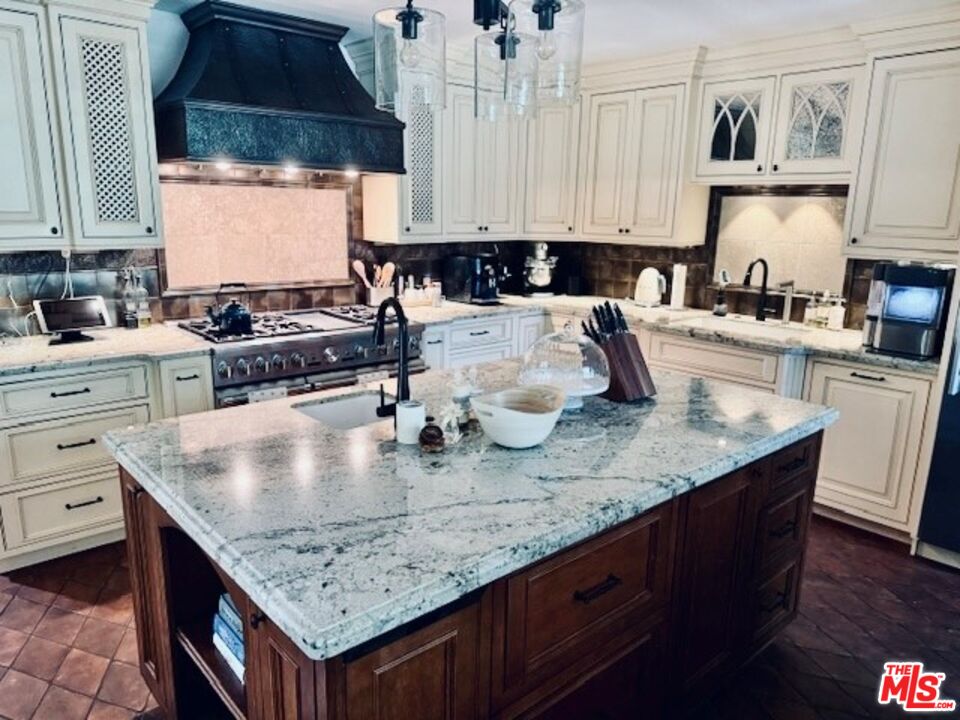 530 Hawthorn Road Sacramento, CA 95864 - Photo 6 of 23 a kitchen with granite countertop a stove a sink and a white cabinets